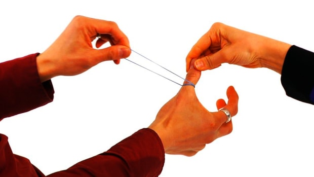 G. How to Do the Rubber Band through the Thumb Trick Promo Image