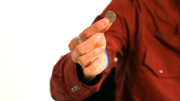 R. How to Do the Fist Squeeze Coin Vanish Office Magic Trick Promo Image