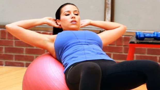 H. How to Do a Crunch with a Ball for Female Strength Training Promo Image