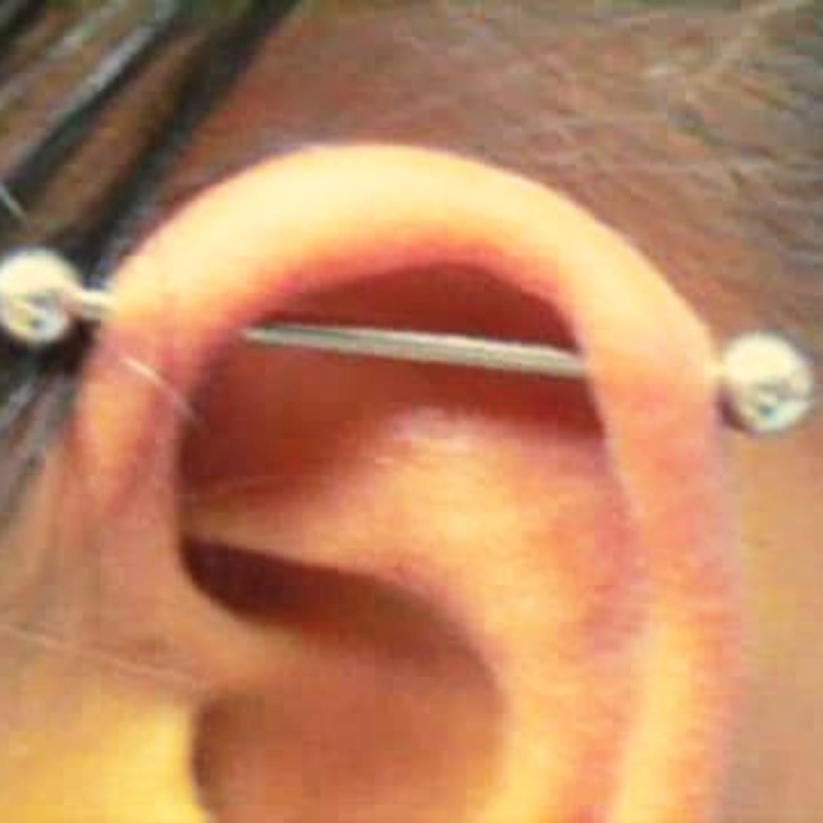 What Is an Industrial Piercing aka Scaffold Piercing Howcast