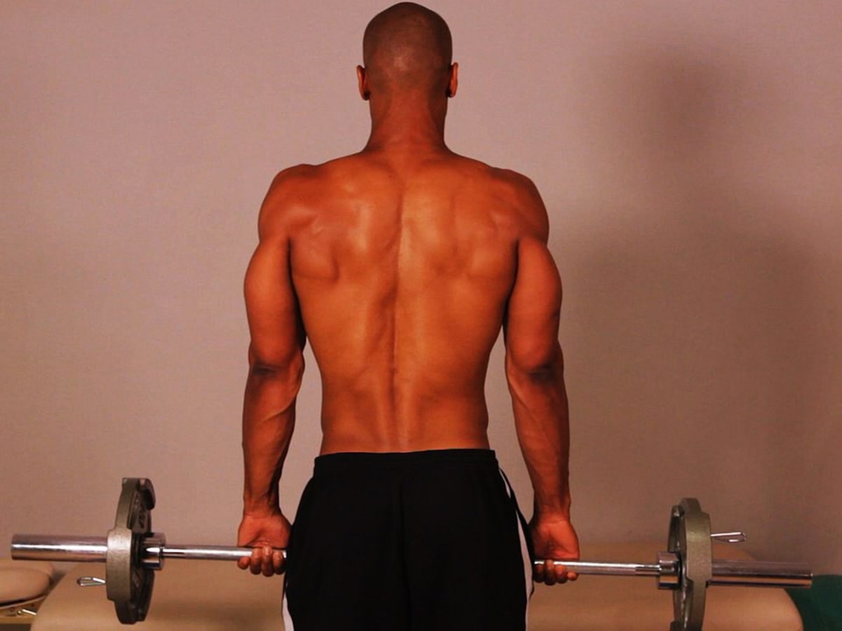 How to Do a Standing Barbell Shrug for a Back Workout Howcast