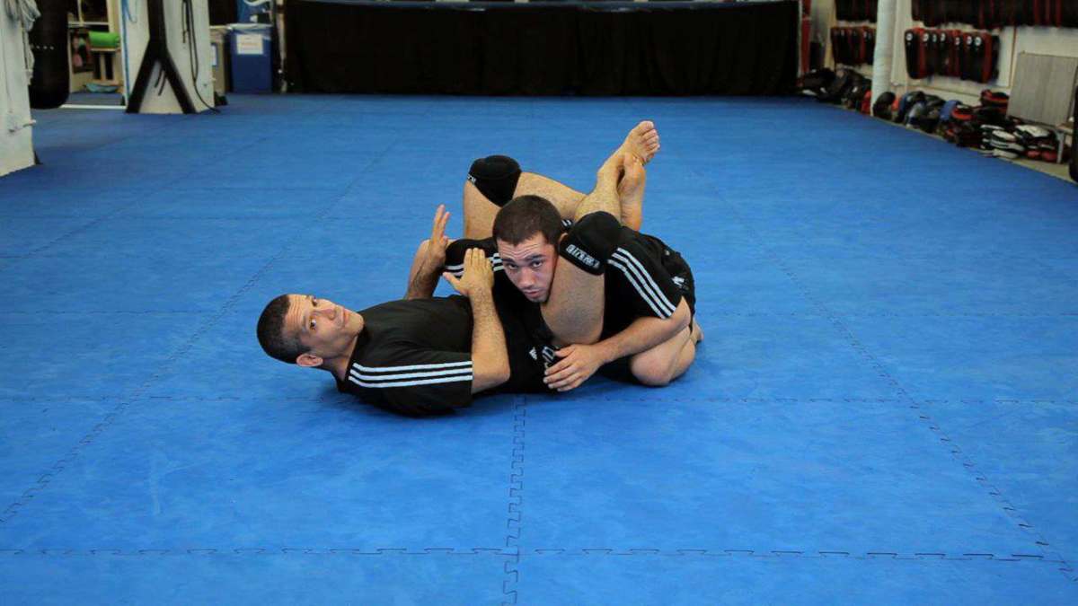 How to Do a Triangle Choke from Guard Using Head Control Howcast