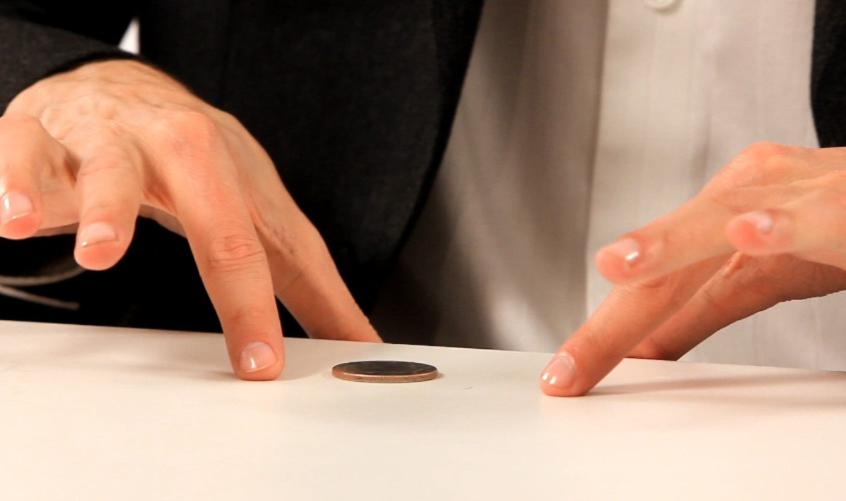 How to Do the Coin through a Table Trick Howcast