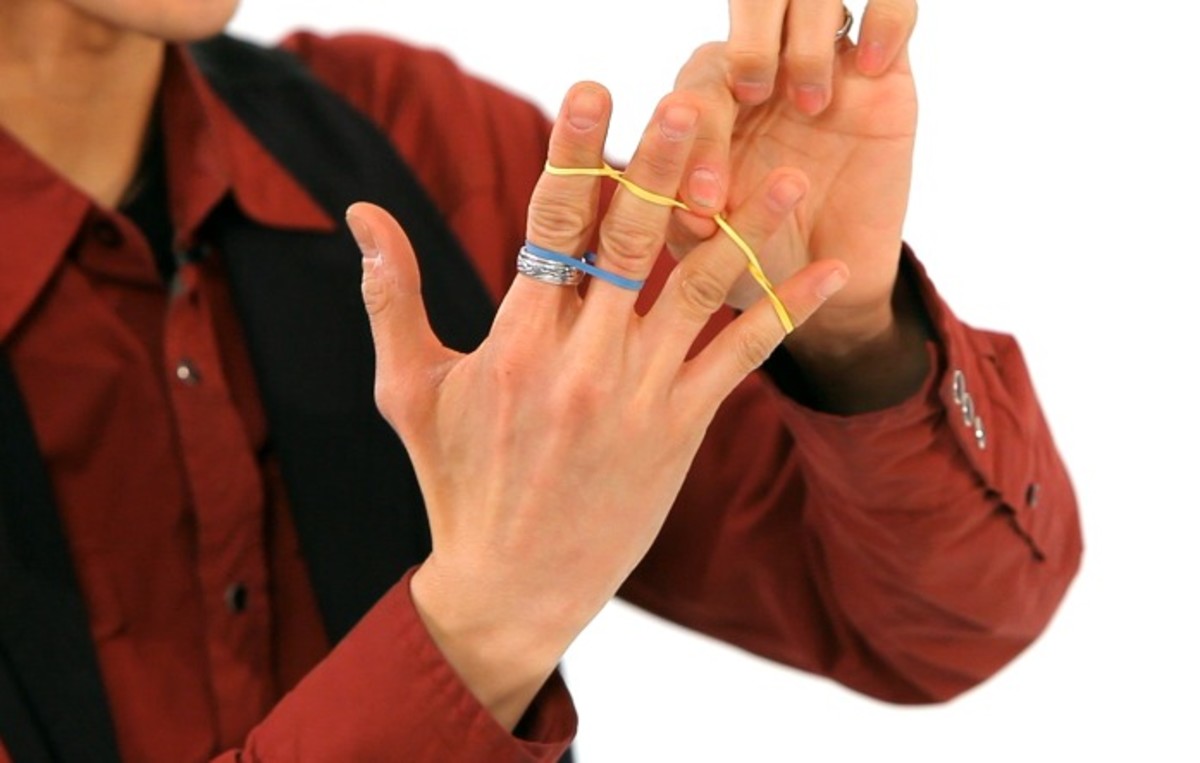 How to Do the Jumping Rubber Band Office Magic Trick Howcast