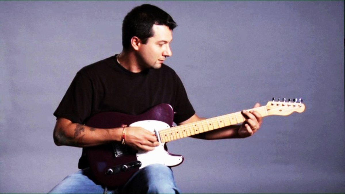 How to Hold a Guitar Properly While Sitting Howcast